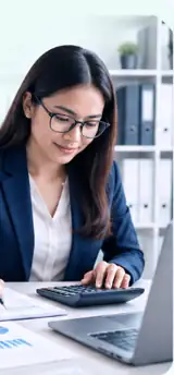 Accountant reviewing financial reports and calculations at her desk