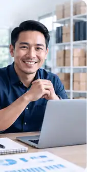 Business owner working on company finances at a laptop